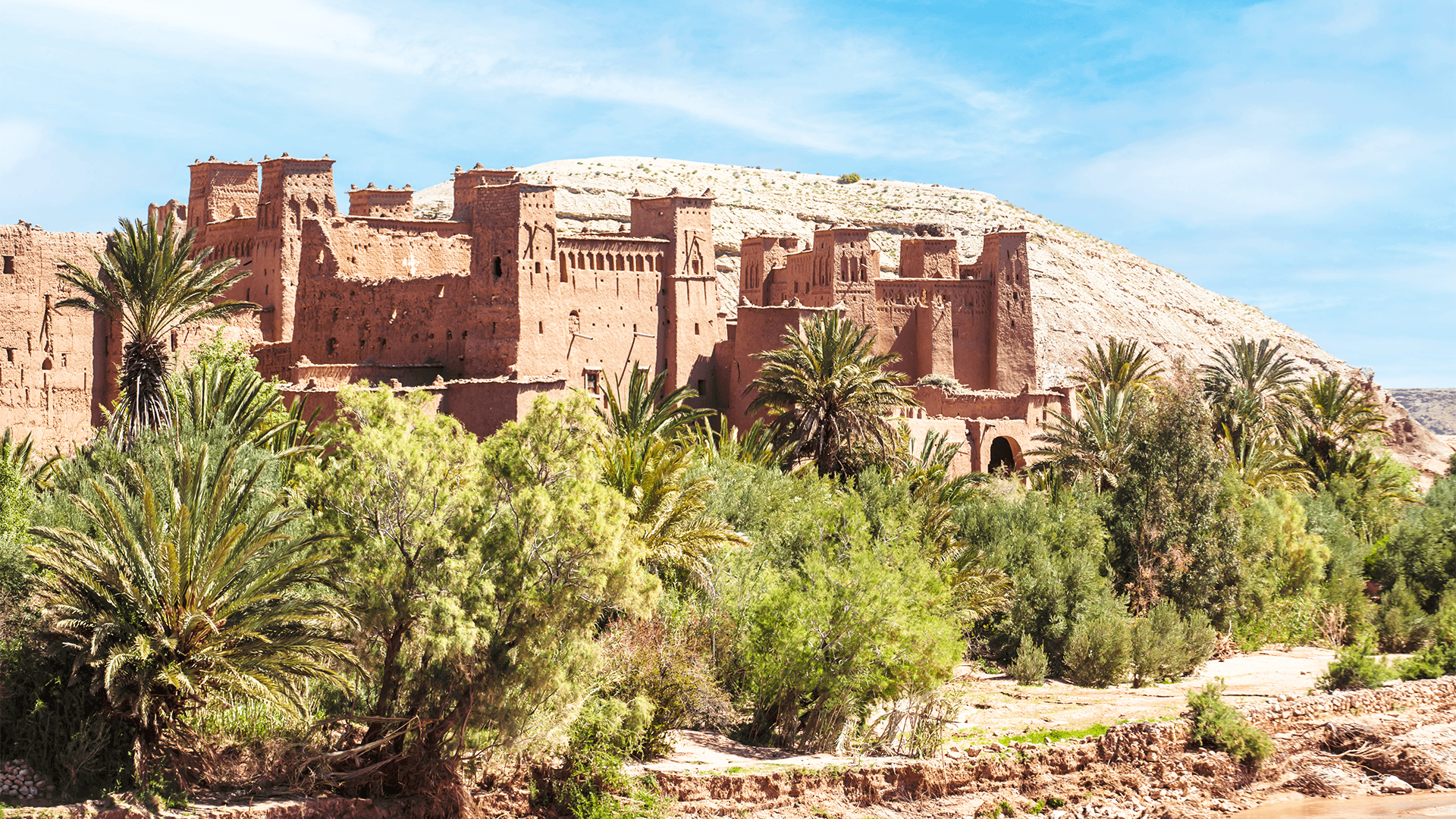 Aït Ben Haddou fortress surrounded by palm trees