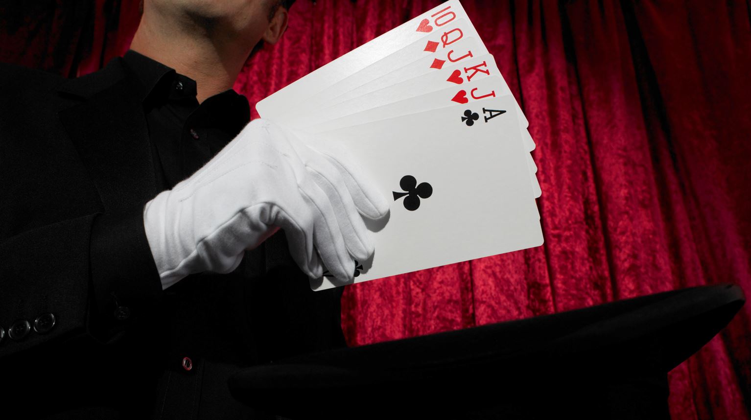 Game cards in a glowed hand of a magician. 