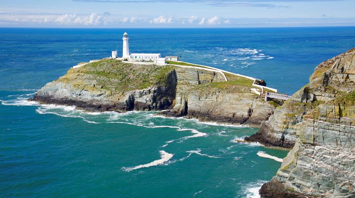 Cliff with a lighthouse on top surrounded by water, Anglesey, Holyhead, South Stack lighthouse, Irish Sea