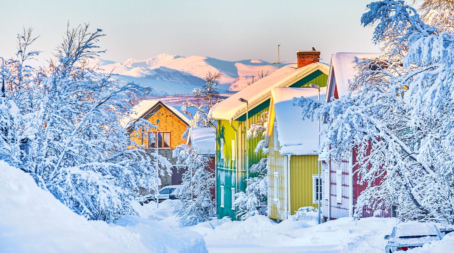 Kiruna houses covered in snow in afternoon light. 