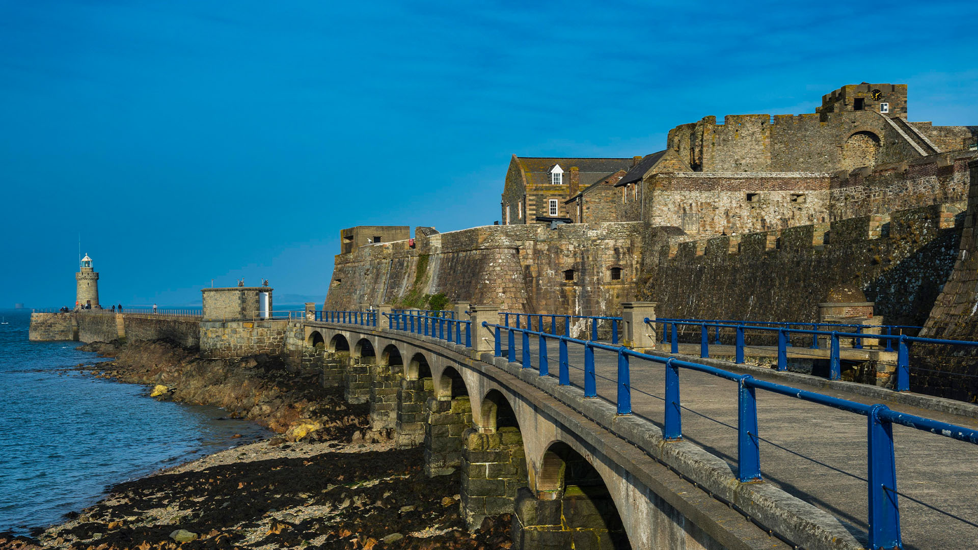 Stone harbour walls and walkway by Castle Cornet