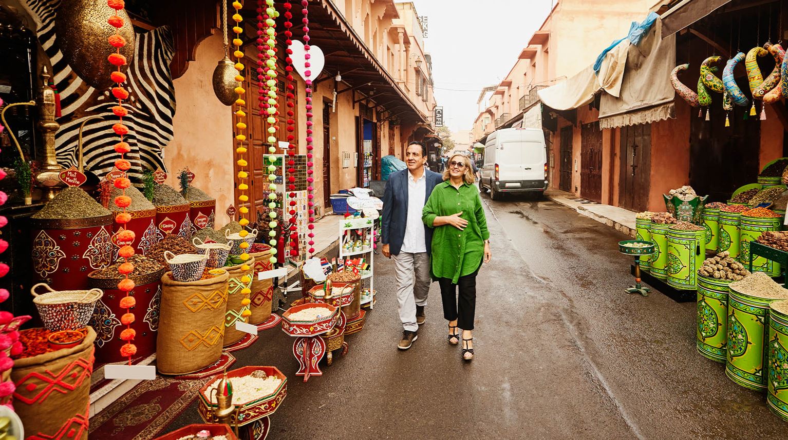 Wide shot of senior couple admiring spice shops in Marrakech 