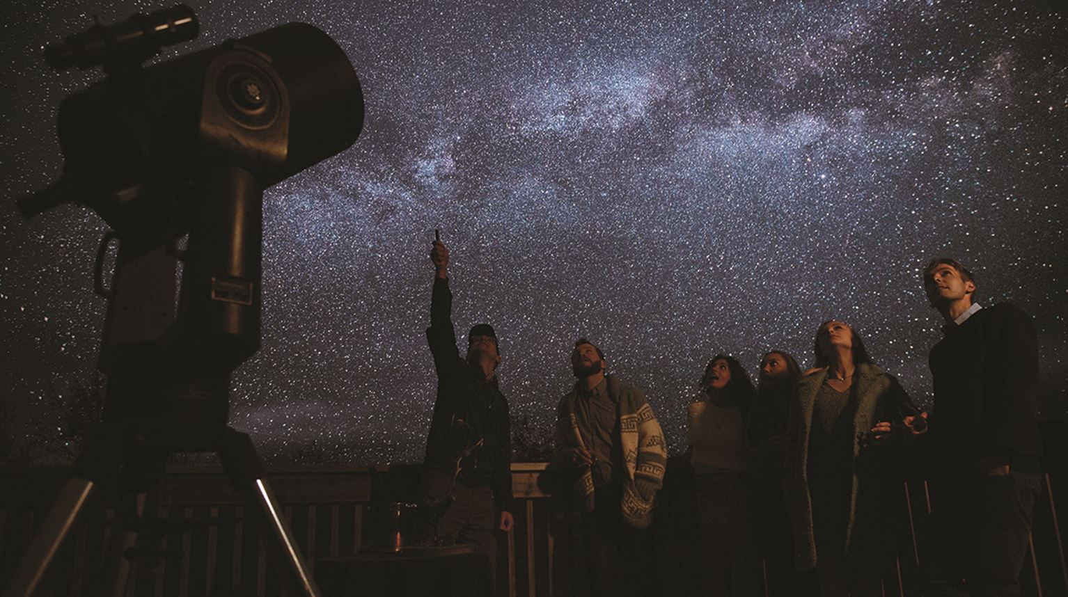 A group of people stargazing at Trout Point Lodge, Nova Scotia