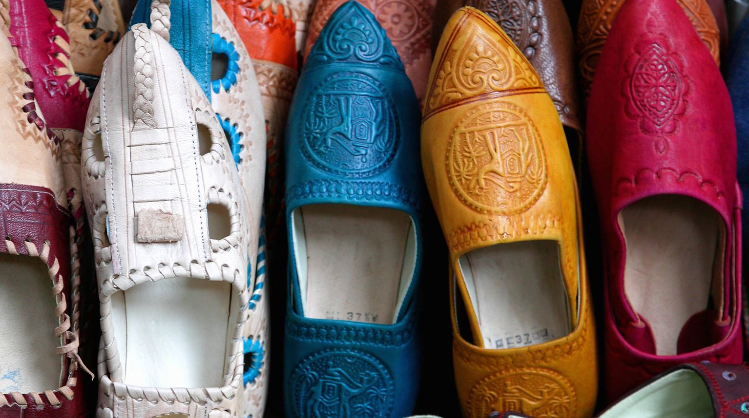 Colourful leather slippers in a row