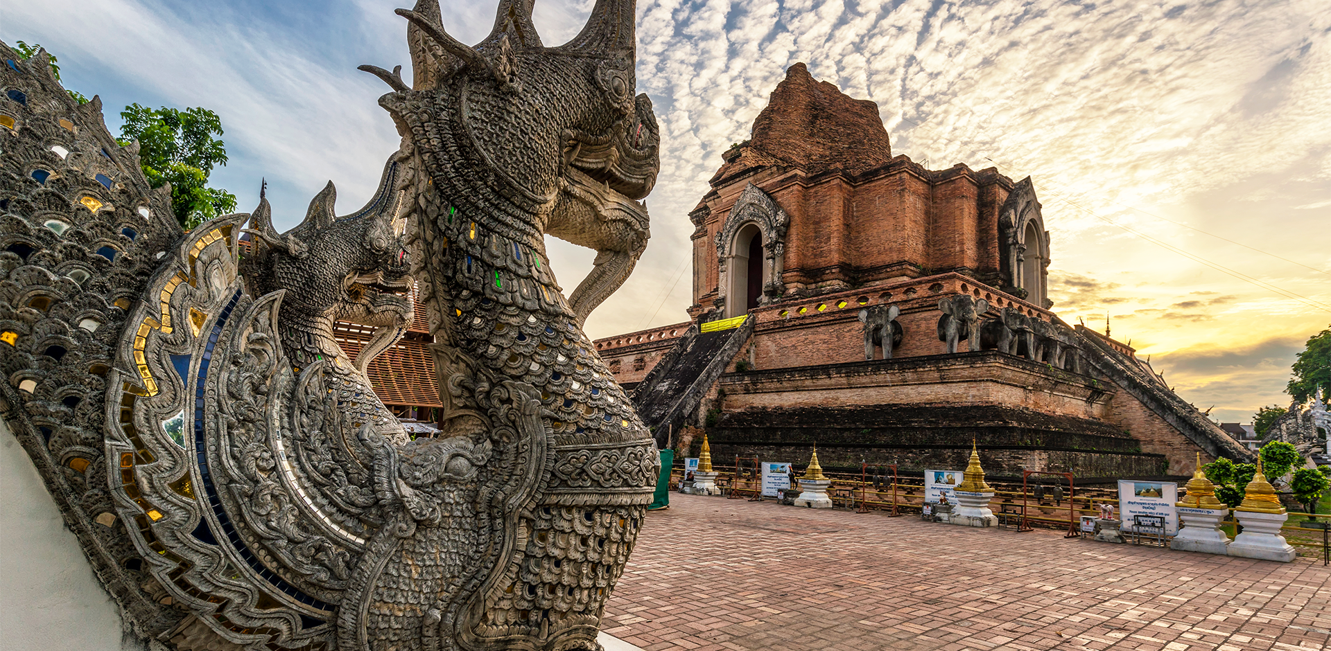 Ornate stone pagoda and dragon sculpture at sunrise