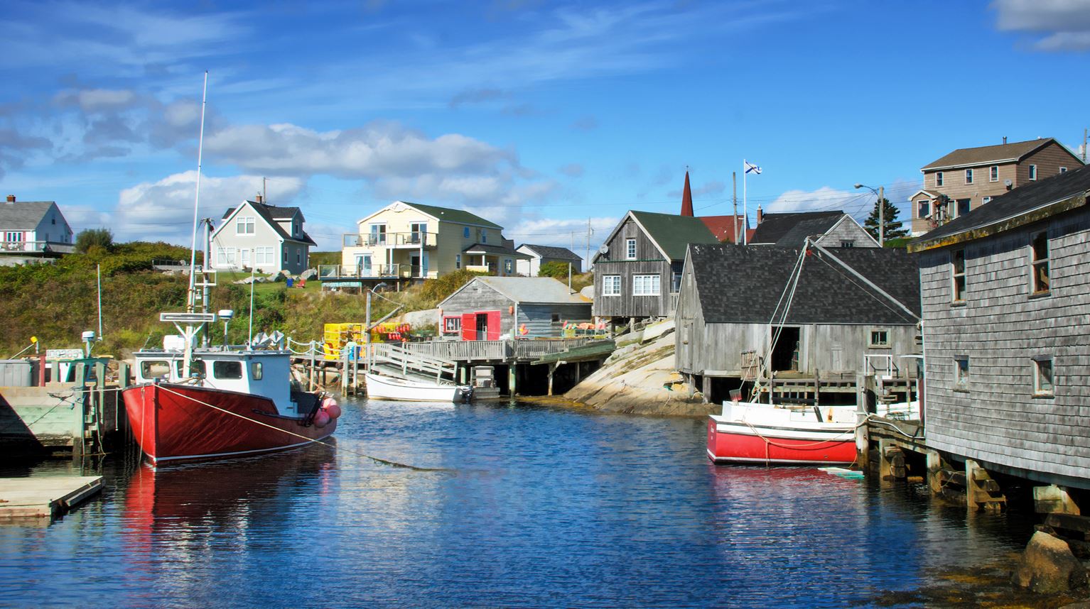 Full View of Peggys Cove town with boats on water, Nova Scotia, Canada