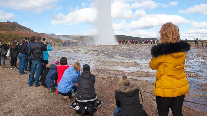A group of tourists in Strokkur Geyser, Iceland