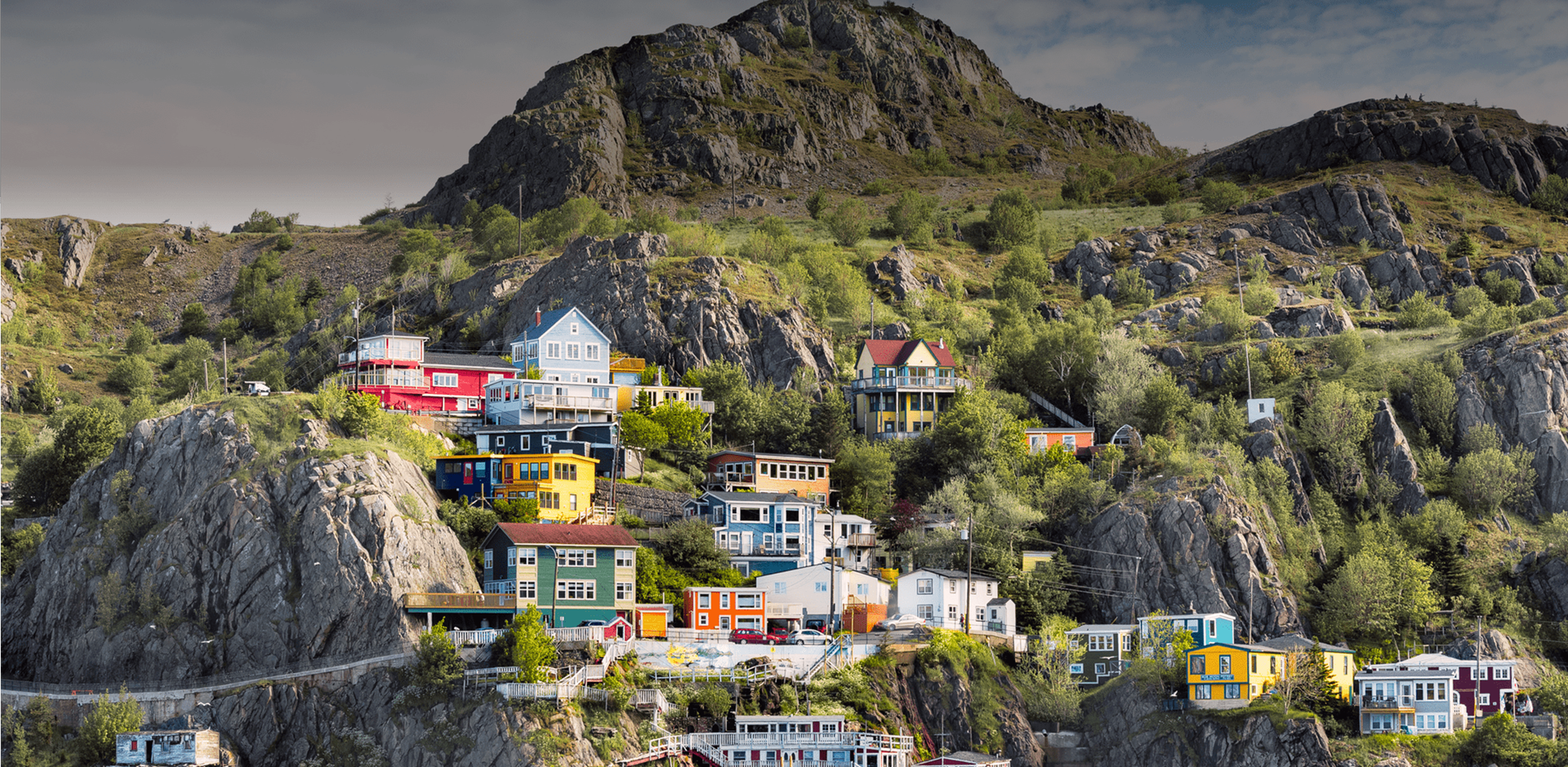 View Of Sea And Mountains with bright houses on rocky hills in St. John's, Canada