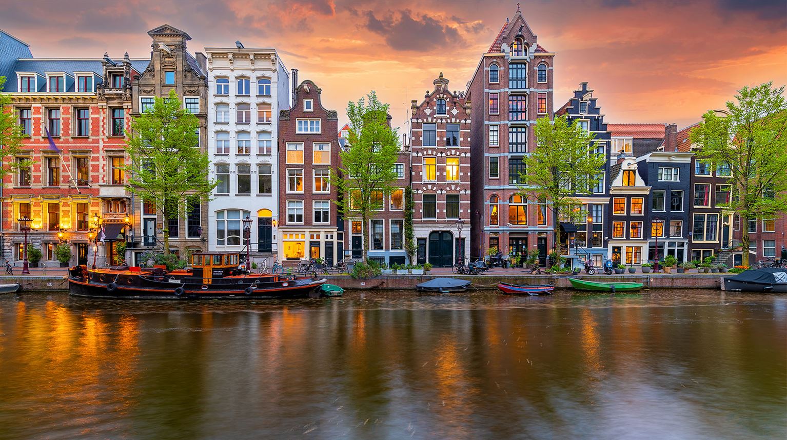 Water canals, boats and colorful houses in Amsterdam, Netherlands