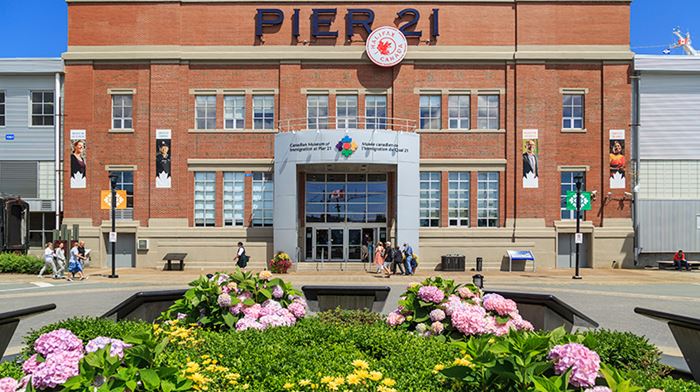 A view of the Canadian Museum of Immigration with flower in the front, at Pier 21.