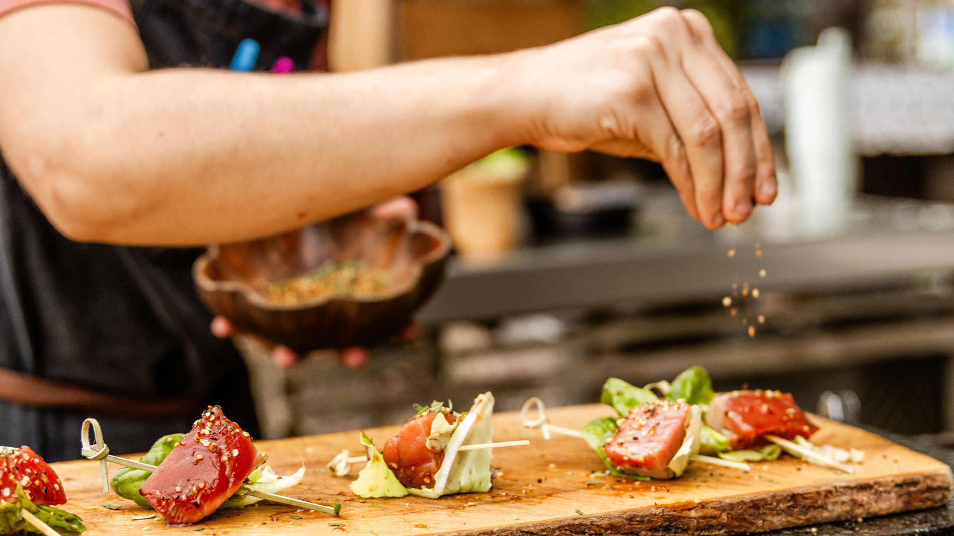 Chef garnishing a platter of appetizers