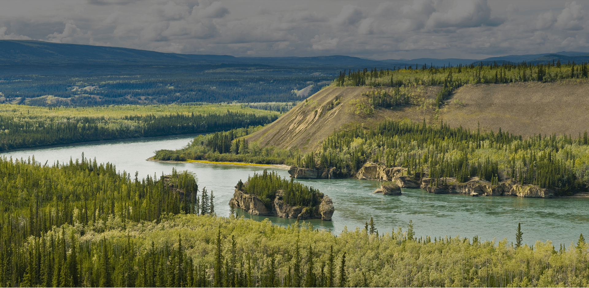 View of Yukon River with hills near Carmacks in Yukon Territory