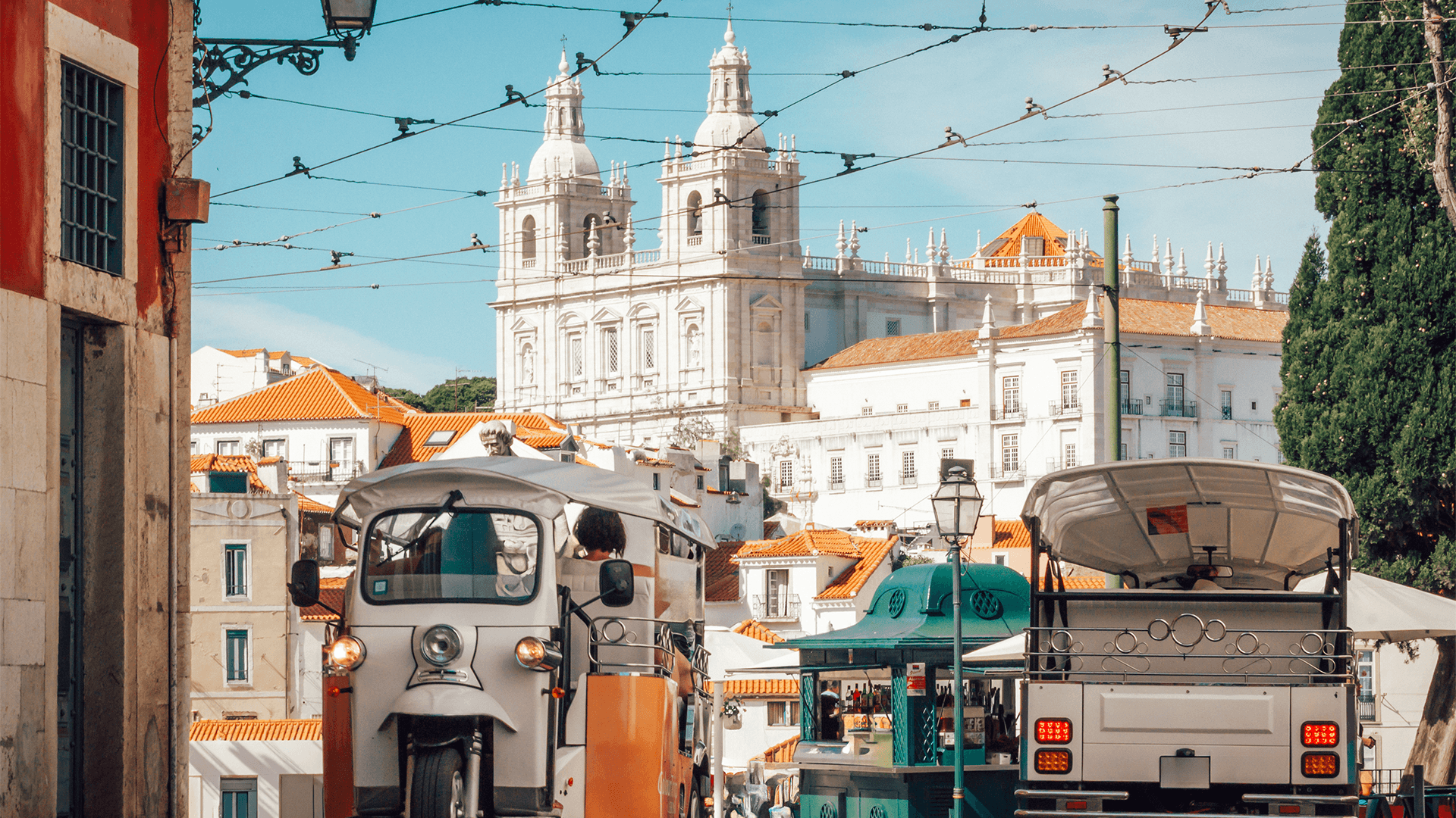 Tourists enjoy a tuk-tuk ride in Lisbon