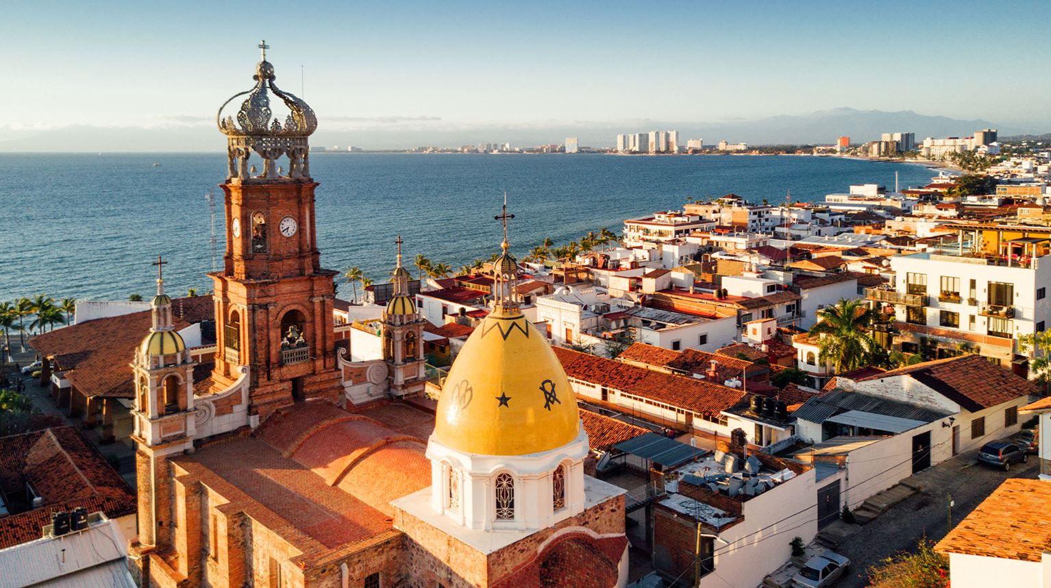 Aerial city view of Spanish-style architecture and sea