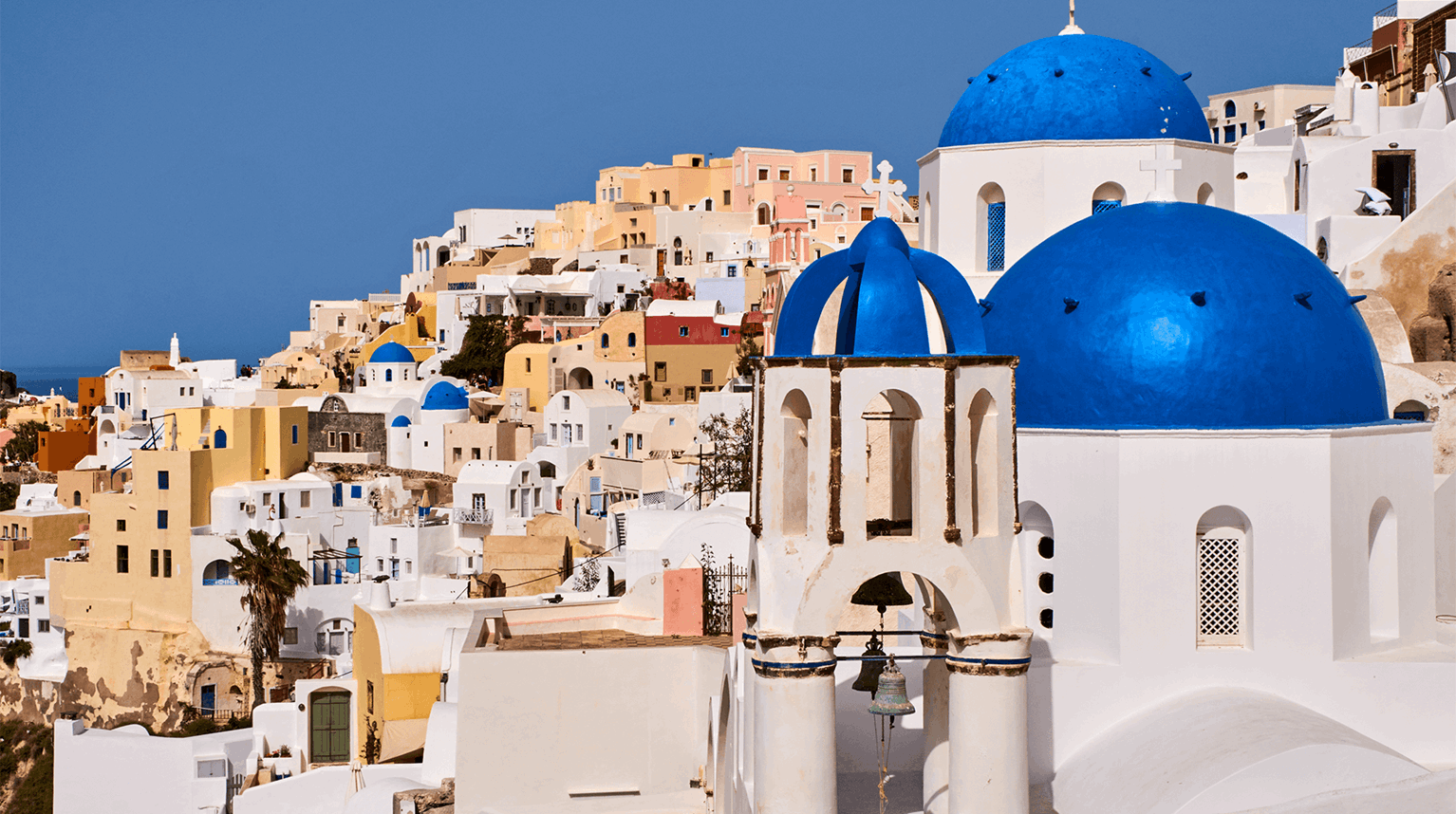 Whitewashed buildings with bright blue church domes
