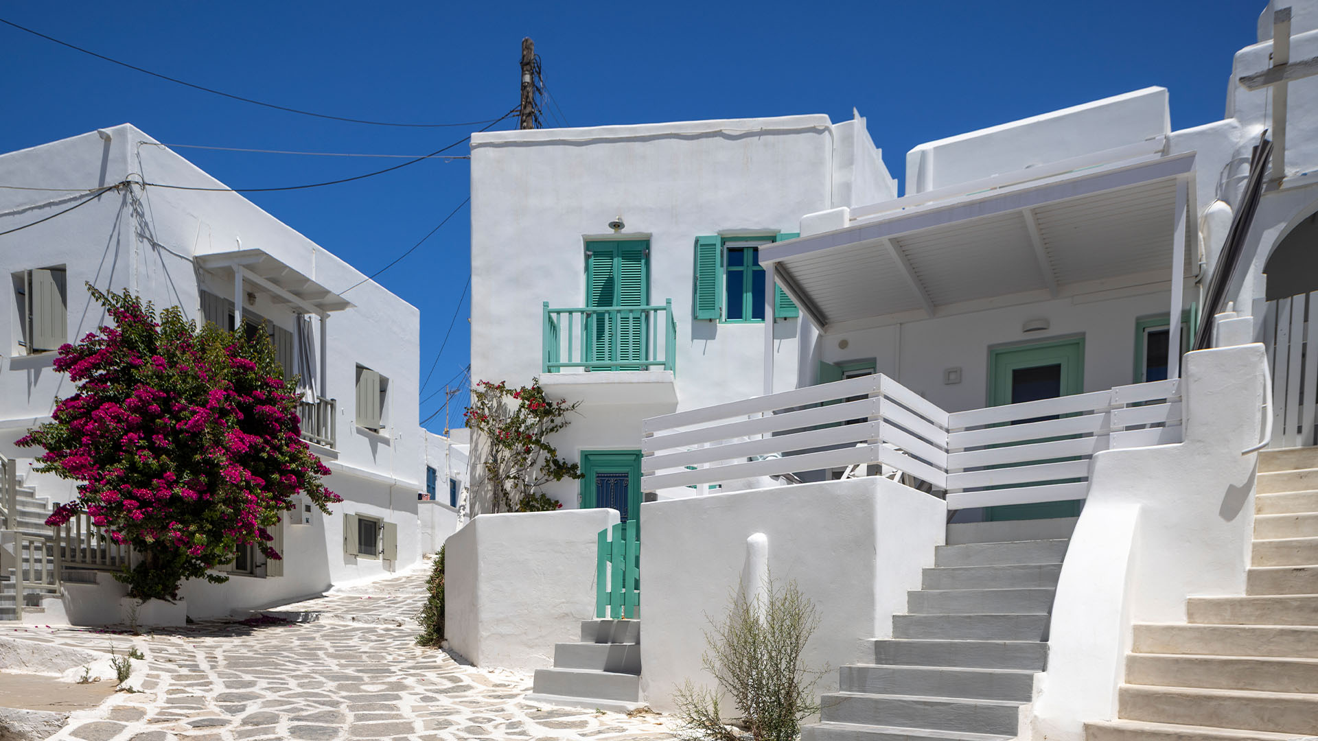 Traditional whitewashed Greek houses against a blue sky