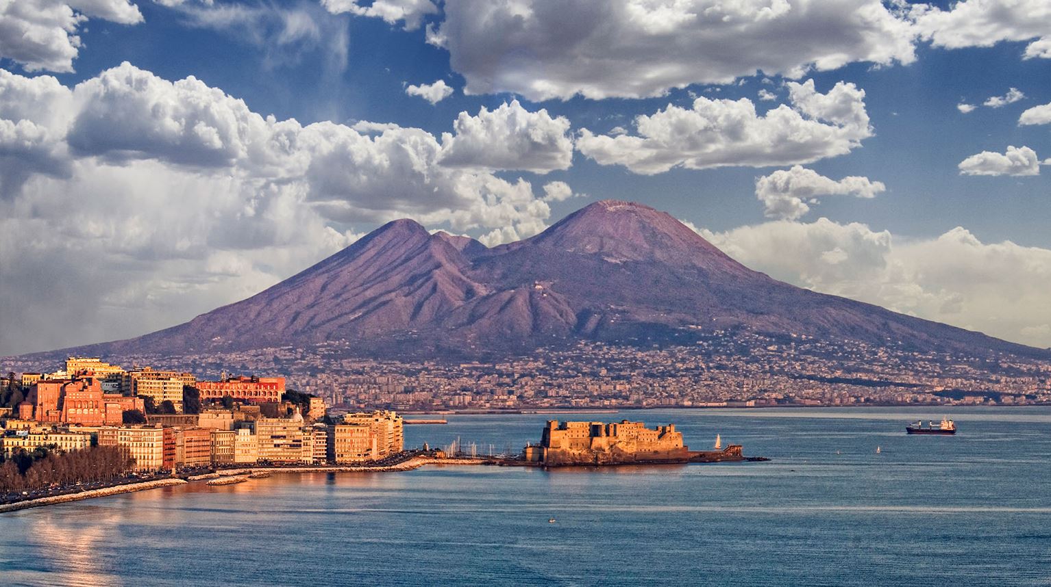 Bay of Naples at sunset with Mount Vesuvius behind. 