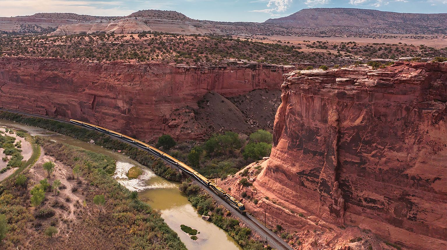 Rocky Mountaineer train in a rustic rugged landscape in Ruby Canyon, Colorado/Utah Border