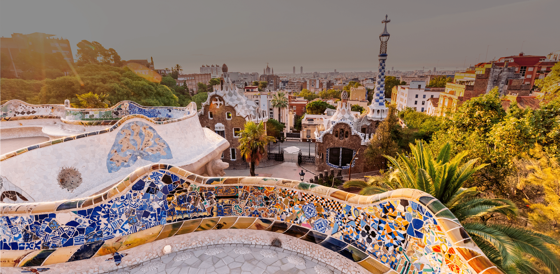 View from Mosaic-covered building of a Park Guell, Barcelona skyline at sunrise, Catalonia, Spain